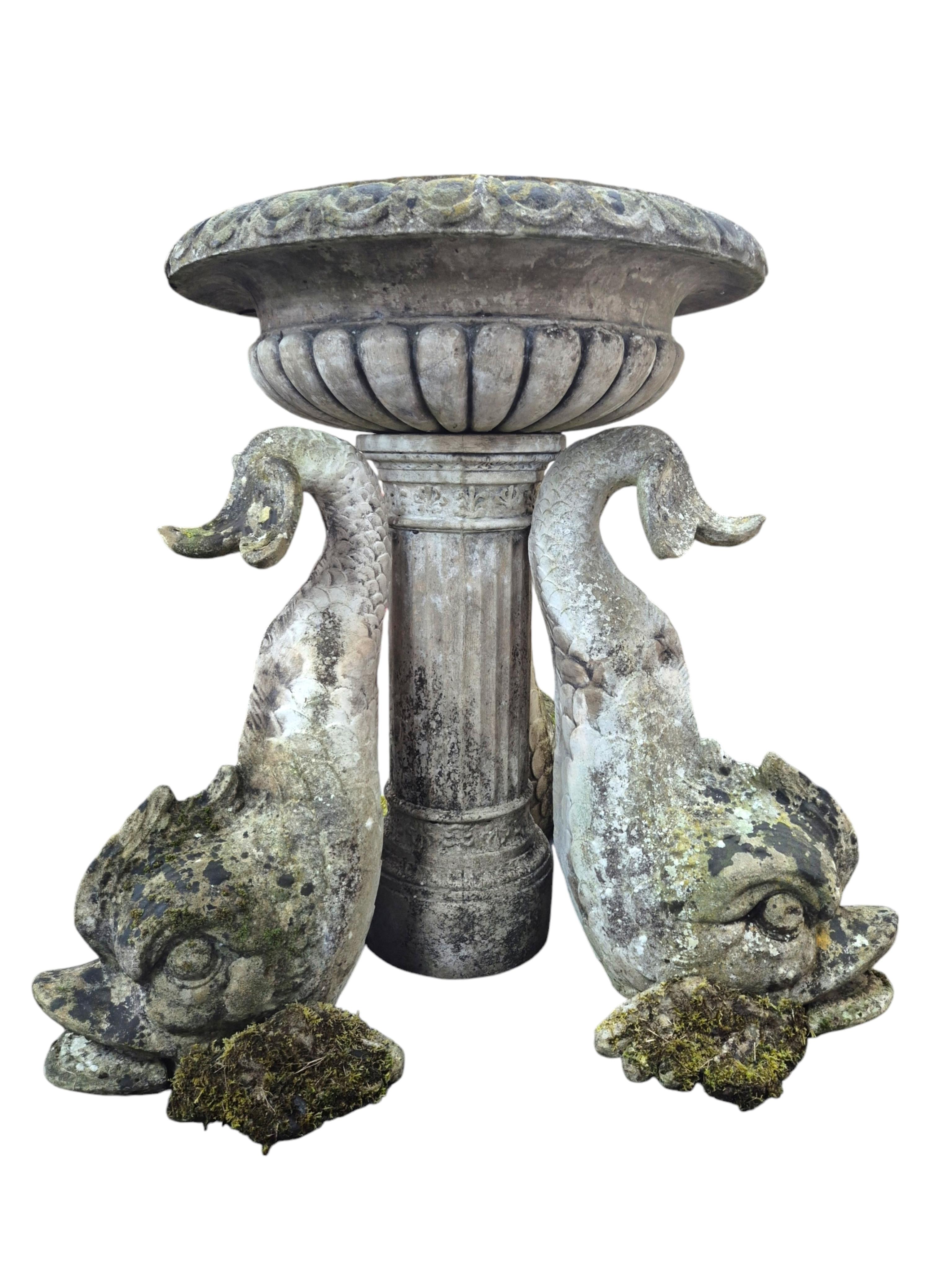 A reconstituted stone bird bath